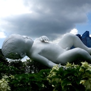 Amazing and huge sculpture of a baby floating above the meadow
